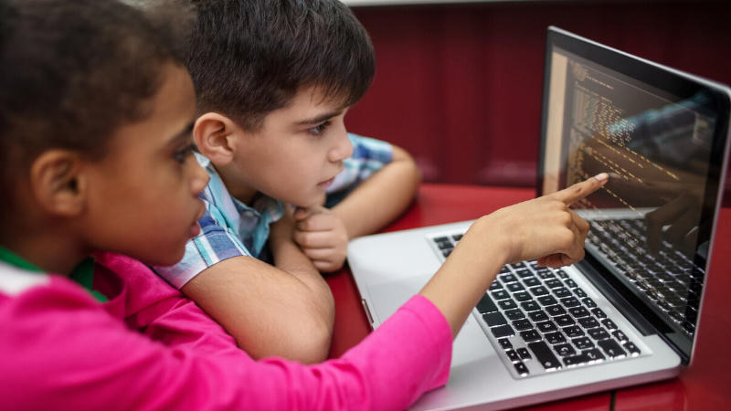Kids collaborating on coding project