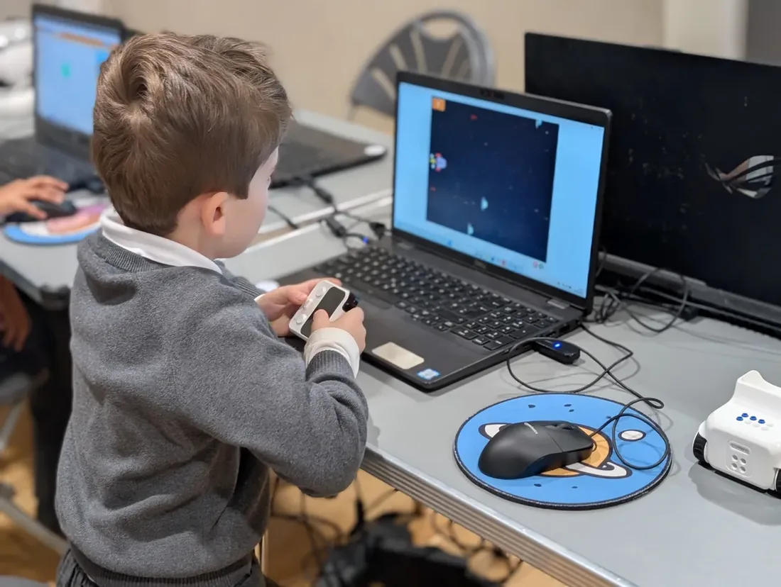 Child coding with laptop